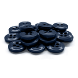 A pile of Work Shirt Buttons in dark blue plastic with four holes, military spec, displayed on a white background.