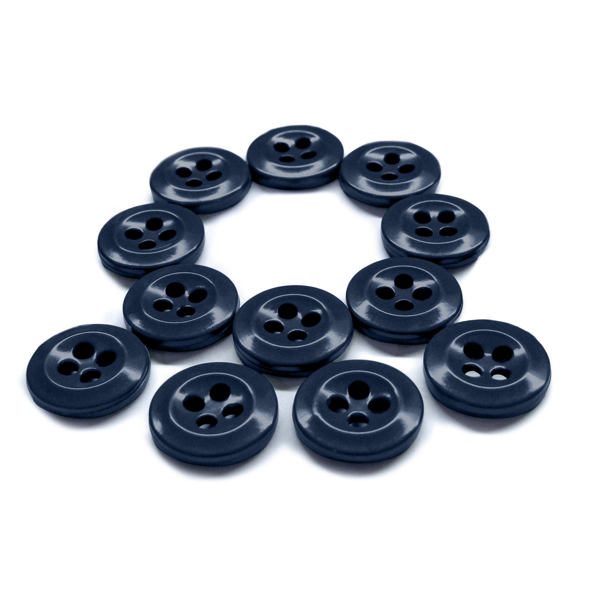 A pack of twelve Work Shirt Buttons is arranged in a circle on a white background. These black buttons are military spec and come in a convenient 12 pack.