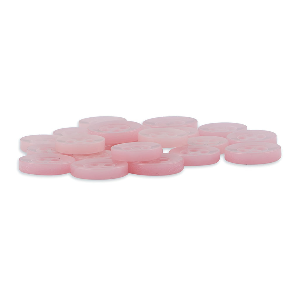A pile of round, light pink Replacement Shirt Buttons with a matte finish and four holes each, arranged on a white background.