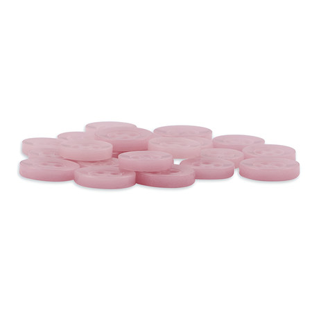 A pile of Replacement Shirt Buttons, round and pink, are scattered on a white background—each one echoing the playful charm of classic poly-nylon buttons from a tailor's kit.
