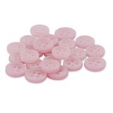 A pile of round, light pink Replacement Shirt Buttons with four holes, made from durable poly-nylon, arranged on a white background.
