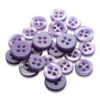 A collection of round, purple, matte Replacement Shirt Buttons is scattered on a white surface.