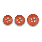 Three Replacement Shirt Buttons in matte red, each with four holes and different sizes, arranged in a row on a white background—ideal spares for any tailor's kit.