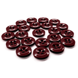 A set of Work Shirt Buttons in dark red military spec, each featuring four holes, displayed on a white surface.