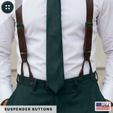 A man in a white shirt, green tie, and pants is wearing brown button-on suspenders attached with authentic Suspender Brace Pant Buttons, made in the USA.