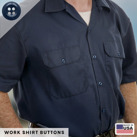 A man wearing a navy work shirt with buttoned chest pockets, featuring durable military spec buttons like those in the Work Shirt Buttons 22 Pack. Made in USA label in the corner.