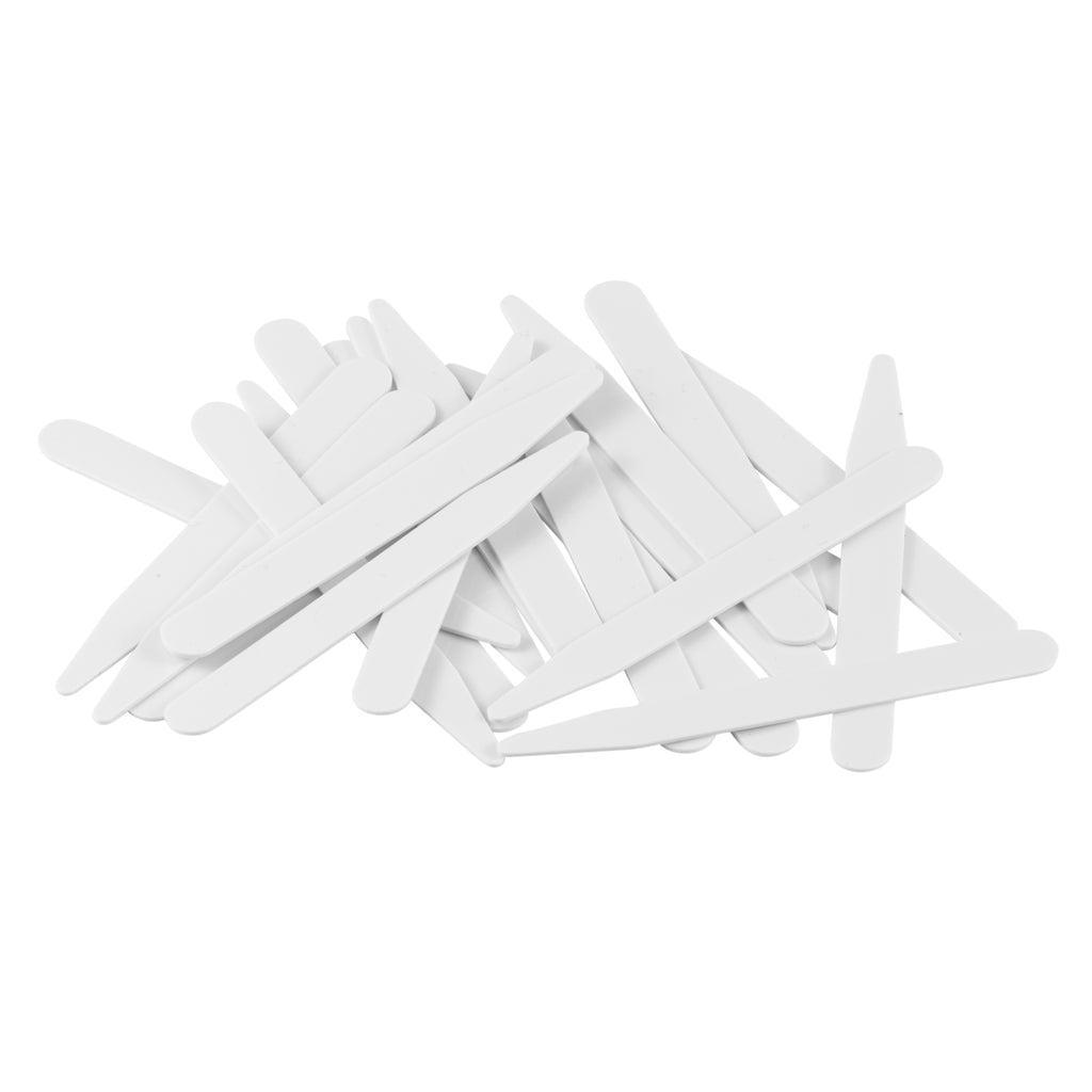 A pile of white Collar Stays, resembling tongue depressors, scattered on a white background.
