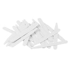 A pile of white Collar Stays, resembling tongue depressors, scattered on a white background.